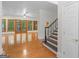 Bright and airy living room with hardwood floors, large windows, and staircase, creating a welcoming atmosphere at 95 Fern Ct, Stockbridge, GA 30281