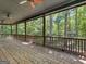 Covered porch with brick floor, wood railing and ceiling fans offering beautiful wooded views at 95 Fern Ct, Stockbridge, GA 30281