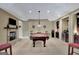 Finished basement area with a pool table, built-in bar, and fireplace at 105 New Castle Ln, Tyrone, GA 30290