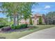 Sprawling home features manicured landscaping, a long driveway, and mature trees at 105 New Castle Ln, Tyrone, GA 30290