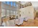 Spacious living room with hardwood floors and tall windows showcases second story balcony at 105 New Castle Ln, Tyrone, GA 30290