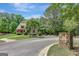 Charming home with a landscaped front yard in a quiet neighborhood; a stone sign marks the community at 105 New Castle Ln, Tyrone, GA 30290