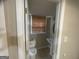 This bathroom features a pedestal sink, toilet, window with blinds, and neutral wall color at 780 Sweet Briar Se Trl, Conyers, GA 30094