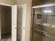 Bathroom with a walk-in shower, neutral tile, and a walk-in closet at 780 Sweet Briar Se Trl, Conyers, GA 30094
