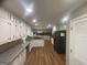 Spacious kitchen featuring stainless steel appliances, wood floors, and white cabinetry at 780 Sweet Briar Se Trl, Conyers, GA 30094