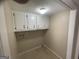 Cozy laundry room with overhead cabinets and hookups for washer and dryer at 780 Sweet Briar Se Trl, Conyers, GA 30094