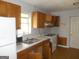 The Kitchen is well-lit with appliances and cabinetry needing some tender loving care at 1391 Peachcrest Rd, Decatur, GA 30032