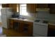 A clean kitchen featuring classic cabinets, gas stove, and a view out the window, ready for a makeover at 1391 Peachcrest Rd, Decatur, GA 30032