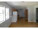 Spacious living room with light wood floors and natural light, transitioning into the kitchen area at 1391 Peachcrest Rd, Decatur, GA 30032