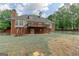 Backyard featuring a deck, patio, and lush greenery at 135 Magnolia Dr, Oxford, GA 30054