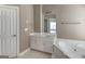 Bathroom featuring a white vanity, built-in tub, and updated fixtures at 135 Magnolia Dr, Oxford, GA 30054