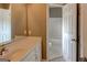 Bathroom features a vanity with a sink and a view into the bathtub and toilet room at 135 Magnolia Dr, Oxford, GA 30054