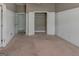 Bedroom with wainscotting, carpeted floor, closet and access to a private ensuite bathroom at 135 Magnolia Dr, Oxford, GA 30054