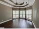 Spacious bedroom featuring large windows, ceiling fan and dark hardwood flooring at 135 Magnolia Dr, Oxford, GA 30054