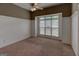 Bedroom with vaulted ceilings, wainscotting and a window providing natural light to the carpeted room at 135 Magnolia Dr, Oxford, GA 30054