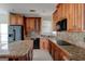 This beautiful kitchen has granite countertops, wooden cabinets, stainless steel appliances, and a central island at 135 Magnolia Dr, Oxford, GA 30054