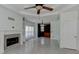 Bright living room with fireplace, ceiling fan and tile flooring offers comfort and style at 135 Magnolia Dr, Oxford, GA 30054