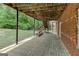 Covered patio with brick wall and staircase at 135 Magnolia Dr, Oxford, GA 30054