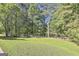 Expansive backyard with lush lawn and mature trees, offering privacy and natural beauty at 180 Willow Lake Ln, Sharpsburg, GA 30277