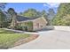 Side view of home showing garage, driveway, and landscaping at 180 Willow Lake Ln, Sharpsburg, GA 30277