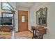 Open foyer featuring light hardwood floors, a vintage sewing table and a decorative mirror at 180 Willow Lake Ln, Sharpsburg, GA 30277