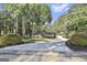 Charming front exterior featuring a circular driveway, manicured landscaping, and a welcoming entrance at 180 Willow Lake Ln, Sharpsburg, GA 30277