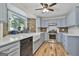 Charming kitchen features stone wall accents, stainless steel appliances, and white countertops at 180 Willow Lake Ln, Sharpsburg, GA 30277