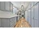 Spacious kitchen features custom cabinets, stainless steel appliances, and hardwood flooring at 180 Willow Lake Ln, Sharpsburg, GA 30277