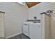 Laundry room with shiplap walls and new washer and dryer at 180 Willow Lake Ln, Sharpsburg, GA 30277