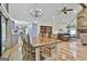 Open-concept living and dining area boasts hardwood floors, stone fireplace, and modern lighting at 180 Willow Lake Ln, Sharpsburg, GA 30277