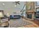 Comfortable living room showcasing a cozy fireplace, plush seating, and ample natural light from expansive windows at 180 Willow Lake Ln, Sharpsburg, GA 30277