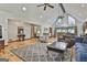 Open concept living room with soaring ceilings, hardwood floors, comfortable seating and views into the dining area at 180 Willow Lake Ln, Sharpsburg, GA 30277