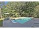 Sparkling pool surrounded by lush greenery, with ample space for lounging and enjoying the summer sun at 180 Willow Lake Ln, Sharpsburg, GA 30277