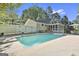 Backyard pool offering a refreshing escape with diving board, and a backdrop of trees, perfect for summer at 180 Willow Lake Ln, Sharpsburg, GA 30277
