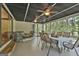 Large sunroom with multiple windows, ceiling fans, and comfortable seating and dining, perfect for relaxation and entertaining at 180 Willow Lake Ln, Sharpsburg, GA 30277