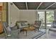 Cozy sunroom with wicker furniture, coffee table and view of the outdoors, perfect for relaxation at 180 Willow Lake Ln, Sharpsburg, GA 30277