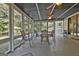 Screened-in porch with dining table and comfortable seating, perfect for enjoying the outdoors while avoiding insects at 180 Willow Lake Ln, Sharpsburg, GA 30277