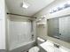Clean bathroom featuring a shower-tub combo, white vanity, and modern lighting at 221 Courthouse Park Dr, Temple, GA 30179