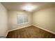 Simple bedroom with neutral walls, carpet, and a window providing natural light at 221 Courthouse Park Dr, Temple, GA 30179