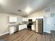 Well-equipped kitchen featuring white cabinets, granite countertops, and stainless steel appliances at 221 Courthouse Park Dr, Temple, GA 30179