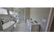 Elegant bathroom with double vanity sinks, glass shower, and freestanding tub with dark fixtures at 1378 Gus Thornhill Jr Dr, East Point, GA 30344