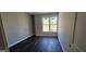Bedroom with warm wooden floors and a window that fills the room with natural light at 1378 Gus Thornhill Jr Dr, East Point, GA 30344