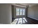 Spacious room features a large window that fills the room with natural light, and modern wooden floors at 1378 Gus Thornhill Jr Dr, East Point, GA 30344
