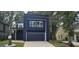 Striking modern home features a beautiful blue exterior, a garage, and lovely green lawn at 1378 Gus Thornhill Jr Dr, East Point, GA 30344