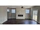 Inviting living room featuring a fireplace and windows that bring in natural light and warm wooden floors at 1378 Gus Thornhill Jr Dr, East Point, GA 30344