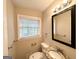 Well-lit bathroom featuring granite vanity top, large mirror, and a window at 1814 Mary Lou Se Ln, Atlanta, GA 30316