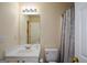 Standard bathroom with white vanity, matching toilet and shower with curtain at 4511 Ravenwood Pl # 70, Union City, GA 30291