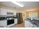Updated kitchen featuring stainless steel appliances and white cabinetry with a view to the dining room at 4511 Ravenwood Pl # 70, Union City, GA 30291