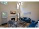 Bright living room with high ceilings, a fireplace, and a view of the outdoors through large windows at 4511 Ravenwood Pl # 70, Union City, GA 30291