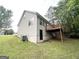 Backyard view with a wooden deck overlooking a spacious lawn and wooded area at 6861 John Clark Dr, Douglasville, GA 30134
